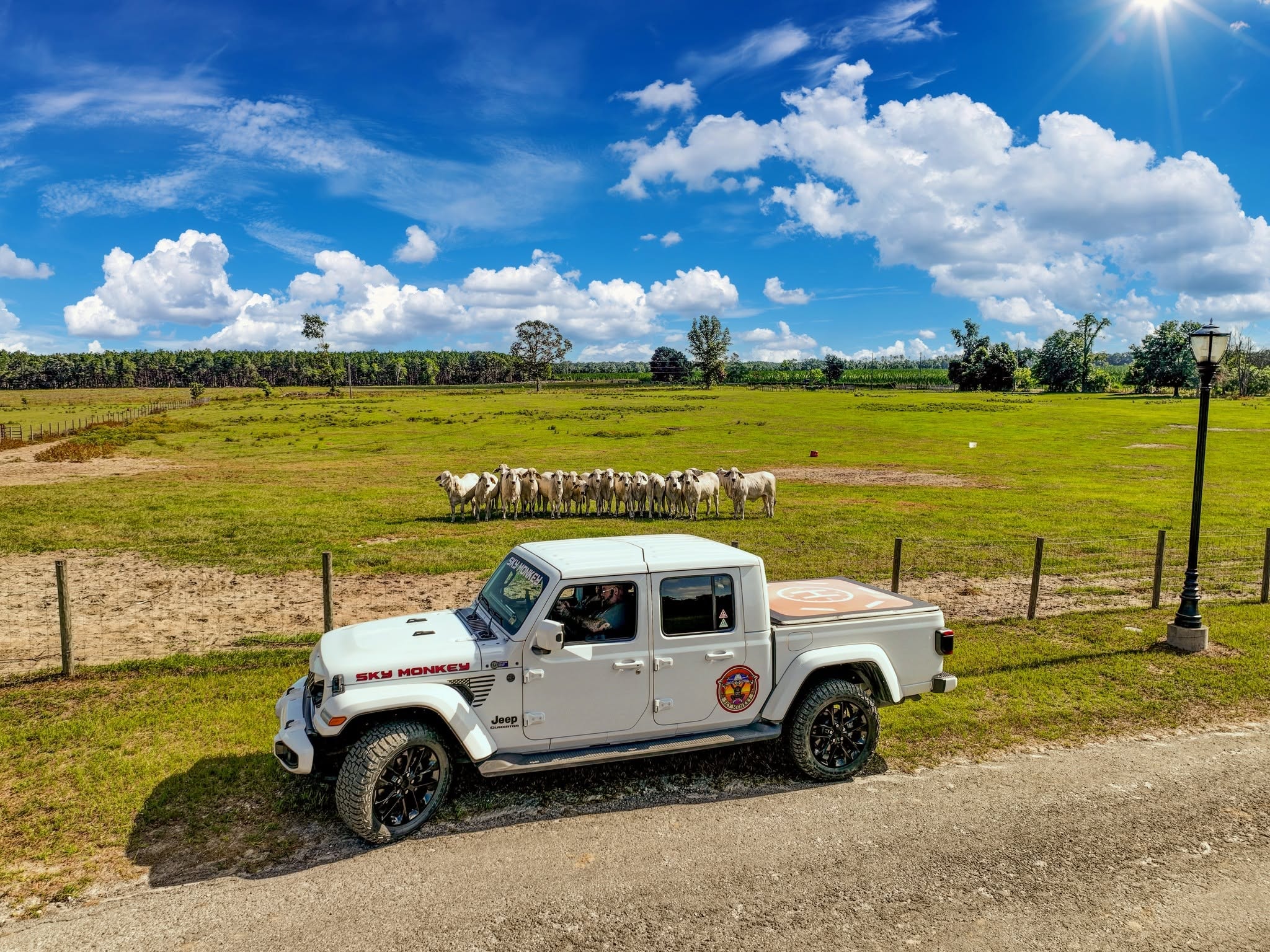 Jason Rathay at the Sky Monkey branded Jeep tailgate with drone gear at a log cabin property