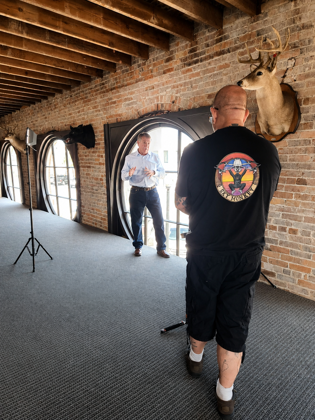 Sky Monkey Media crew on set — directing a client in a brick loft studio